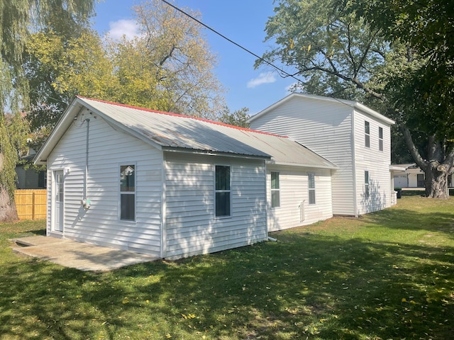 view of side of home with a lawn