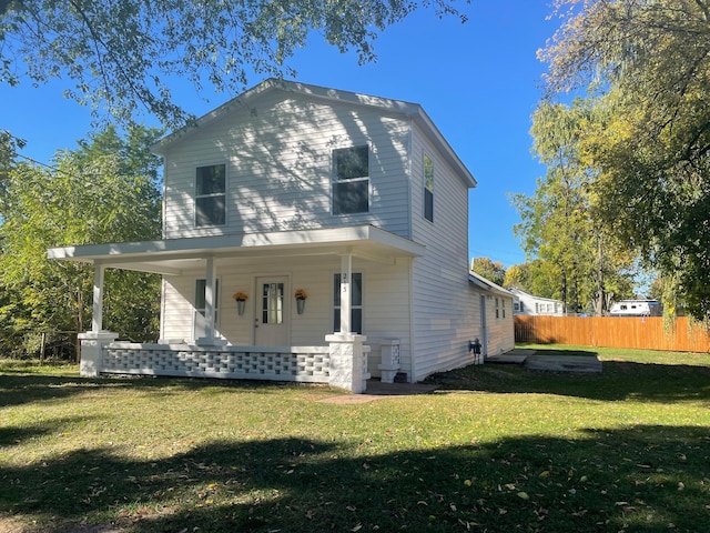 back of property with a porch and a lawn