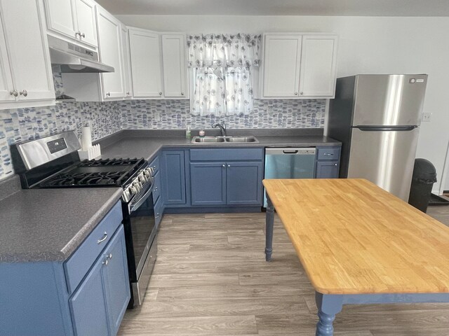 kitchen featuring white cabinets, appliances with stainless steel finishes, and sink