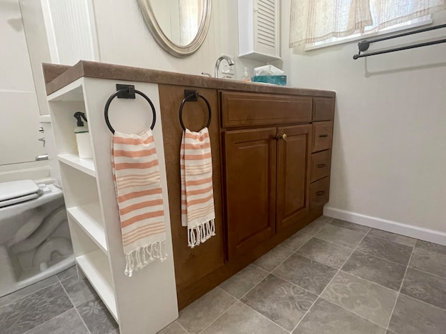 bathroom featuring vanity and toilet