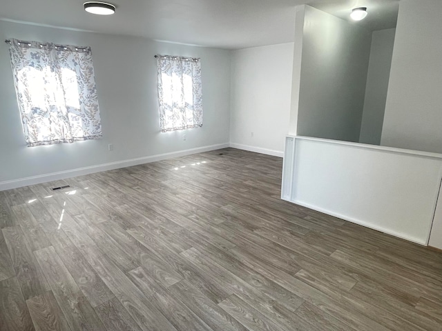 empty room with dark hardwood / wood-style floors