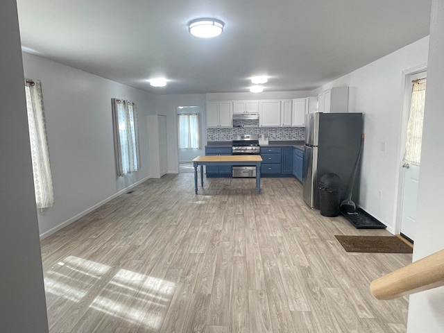 kitchen featuring white cabinetry, blue cabinets, backsplash, light hardwood / wood-style floors, and appliances with stainless steel finishes