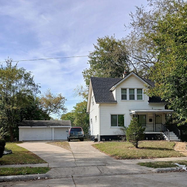 view of front of house featuring a porch, a front lawn, an outdoor structure, and a garage