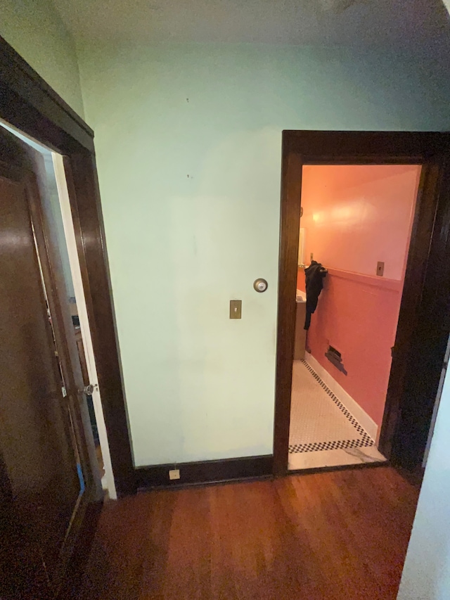 hallway with hardwood / wood-style flooring