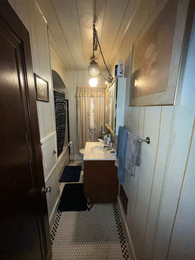 15782 Ohio St, Detroit, MI 48238 - full bathroom with shower / bath combo, toilet, tile patterned flooring, wooden walls, and vanity