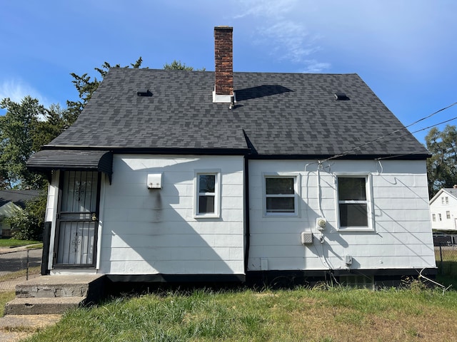 20400 Monica St, Detroit, MI 48221 - rear view of property with roof with shingles and a chimney