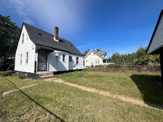 20400 Monica St, Detroit, MI 48221 - back of house with a chimney and a shingled roof