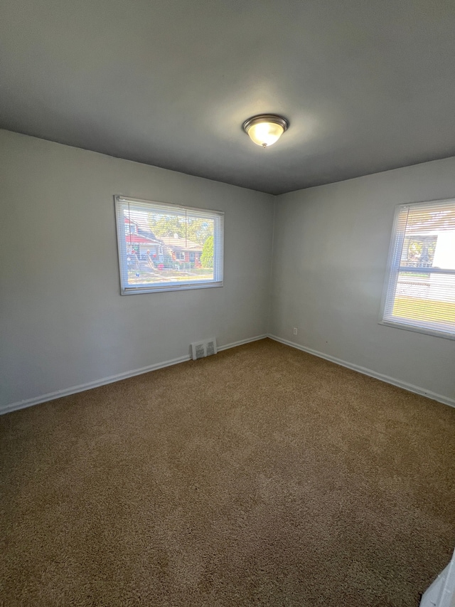 unfurnished room with carpet floors