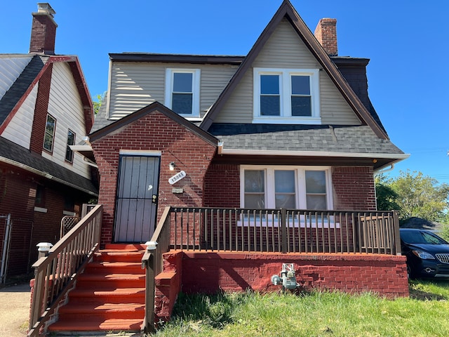 15361 Wisconsin St, Detroit, MI 48238 - view of front facade with brick siding, a shingled roof, a chimney, and a porch