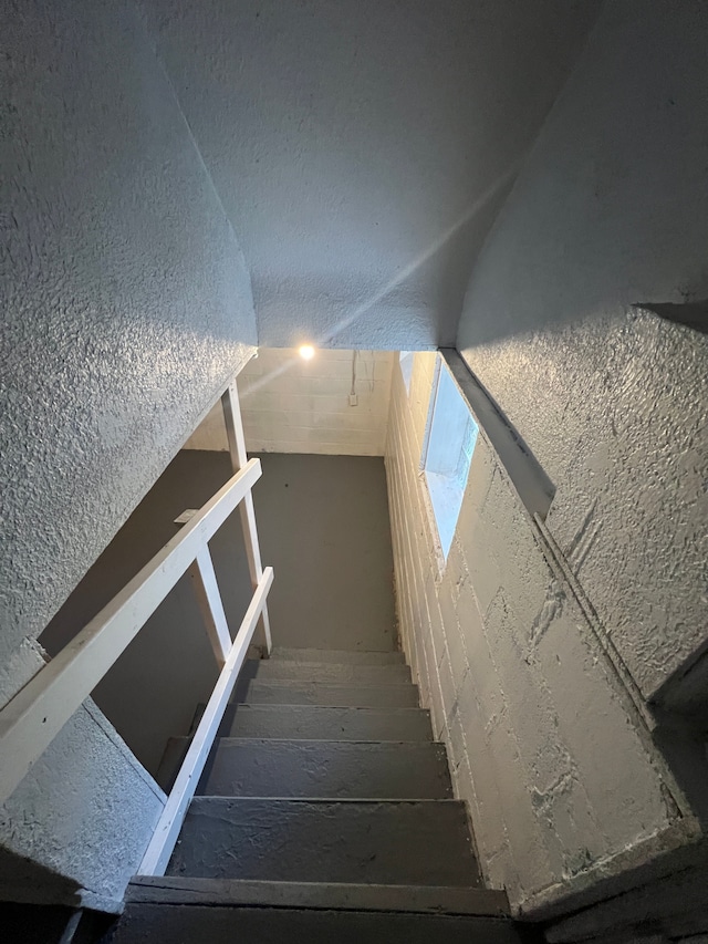 staircase featuring vaulted ceiling