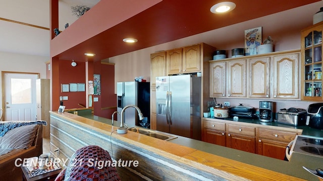 kitchen with recessed lighting, stainless steel fridge, white electric range, and a sink