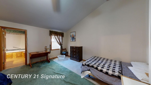 bedroom featuring connected bathroom, baseboards, carpet, and lofted ceiling