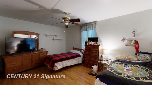 bedroom with ceiling fan and wood finished floors