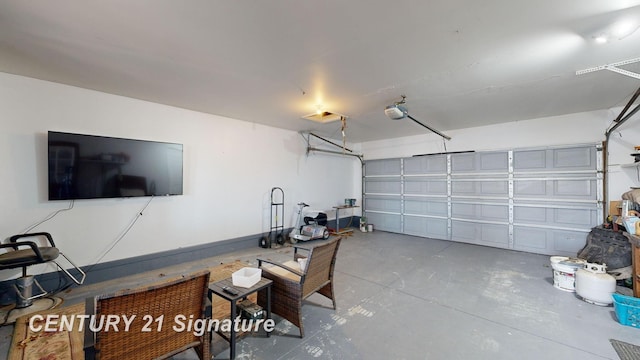 garage featuring a garage door opener and baseboards