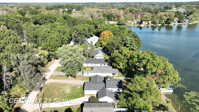 drone / aerial view with a view of trees and a water view