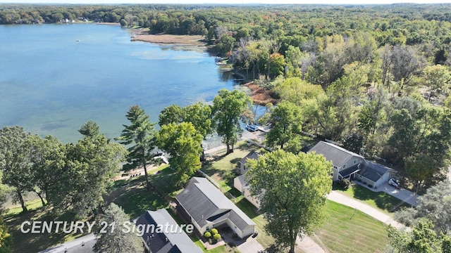 aerial view featuring a wooded view and a water view