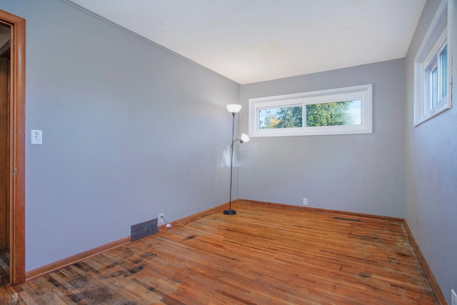 spare room with hardwood / wood-style floors