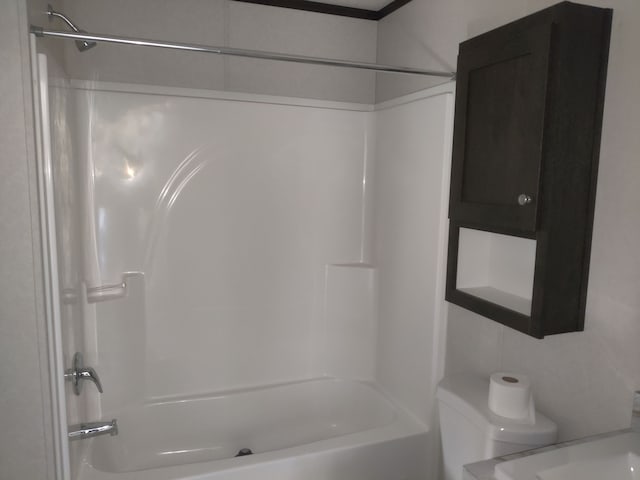 bathroom featuring toilet and bathing tub / shower combination