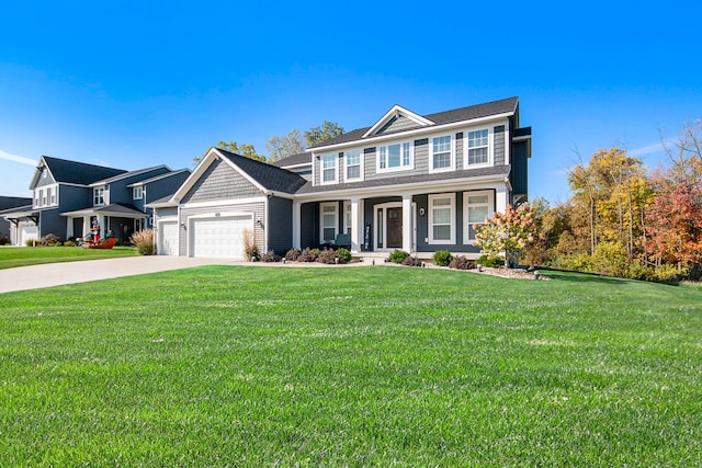 view of front of home featuring a front lawn, covered porch, and a garage