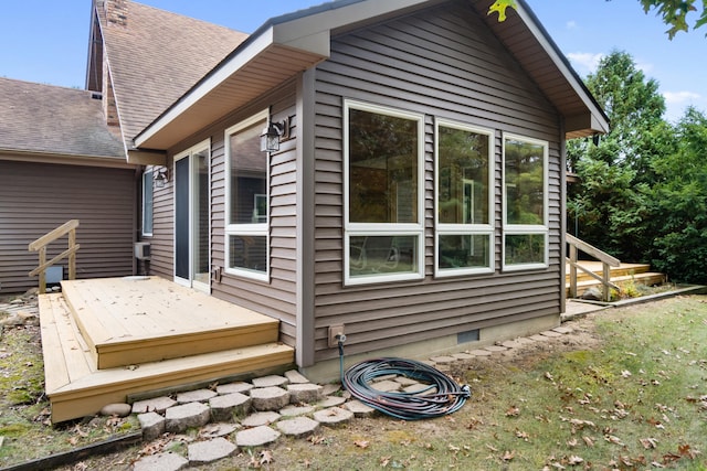 view of home's exterior featuring a wooden deck