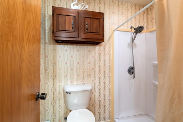 bathroom with toilet and walk in shower