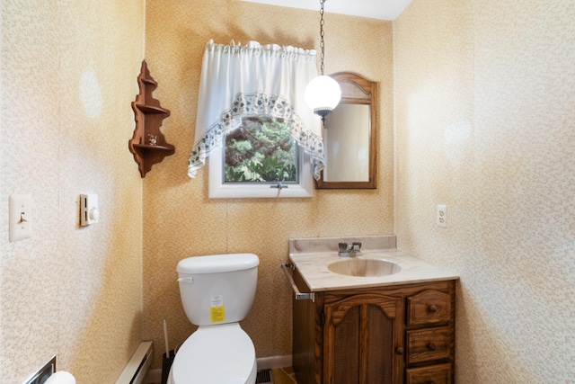 bathroom featuring a baseboard radiator, toilet, and vanity