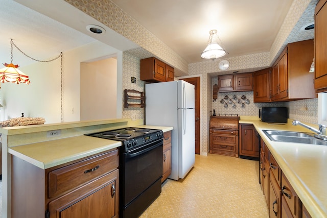 kitchen featuring decorative light fixtures, kitchen peninsula, sink, black / electric stove, and white refrigerator