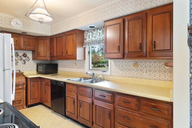 kitchen with decorative light fixtures, sink, and black appliances