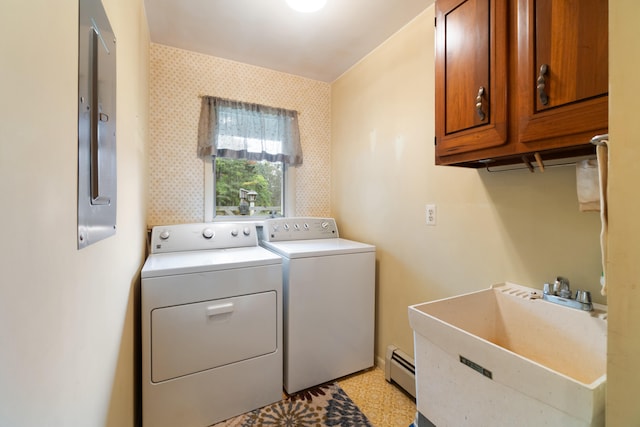 laundry room featuring sink, baseboard heating, independent washer and dryer, and cabinets