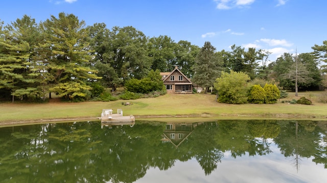 dock area with a water view and a yard