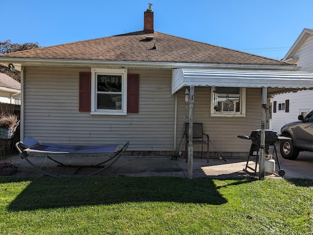 rear view of property with cooling unit and a lawn