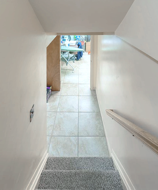 stairs with tile patterned floors and vaulted ceiling