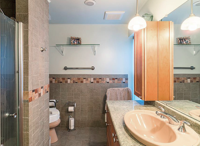 bathroom featuring vanity, toilet, a shower with shower curtain, and tile walls