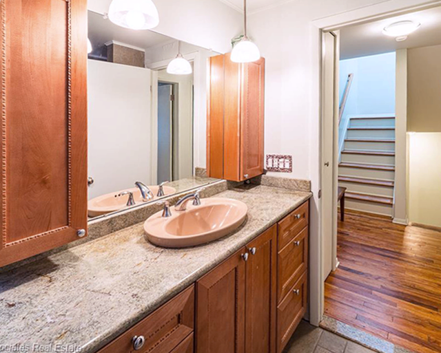 bathroom featuring vanity, ornamental molding, and hardwood / wood-style floors