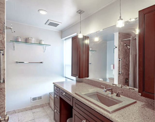 bathroom with vanity and curtained shower