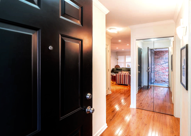 hall with ornamental molding and light wood-type flooring