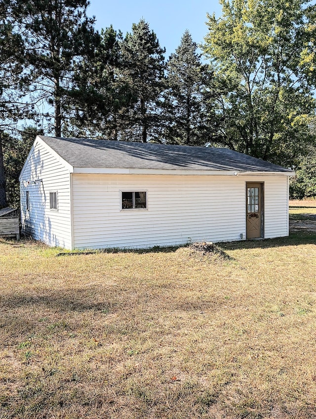 view of outbuilding with a lawn