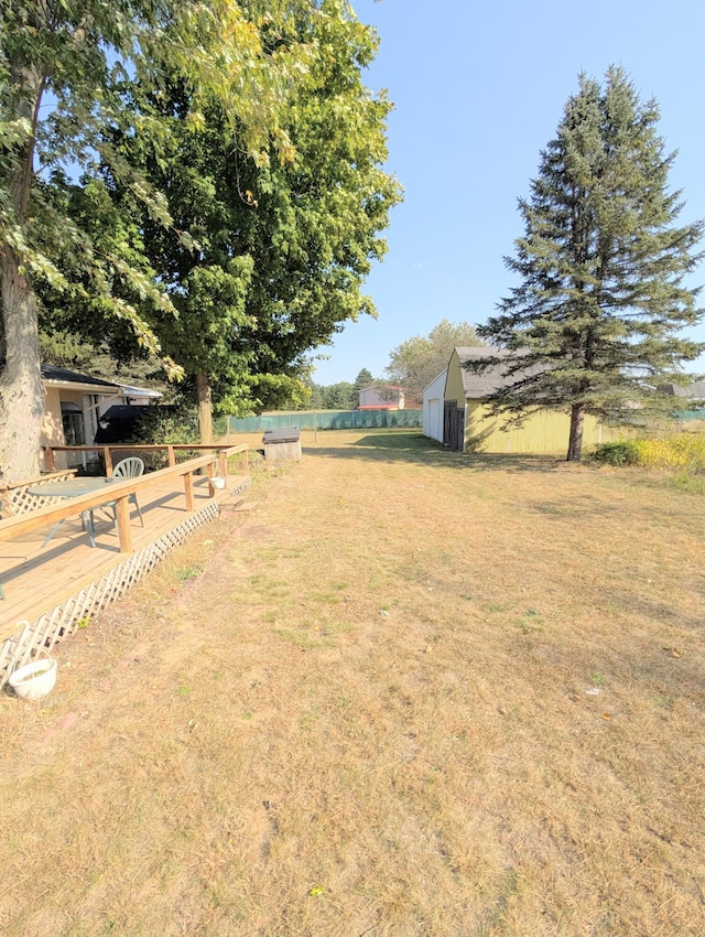 view of yard with a storage shed and a wooden deck