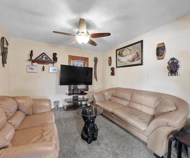 carpeted living room featuring ceiling fan and a textured ceiling