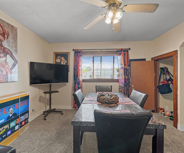 carpeted dining space with ceiling fan and a textured ceiling