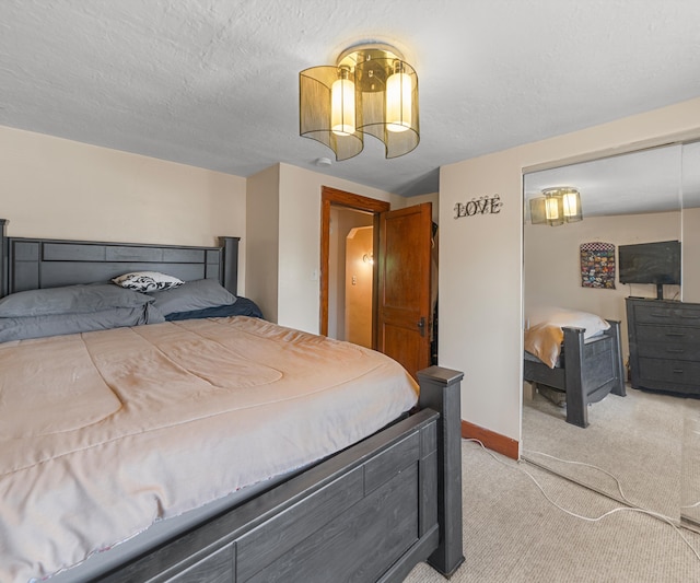 carpeted bedroom featuring a textured ceiling