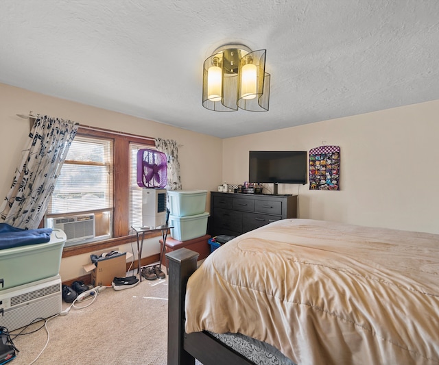 carpeted bedroom featuring a textured ceiling and cooling unit