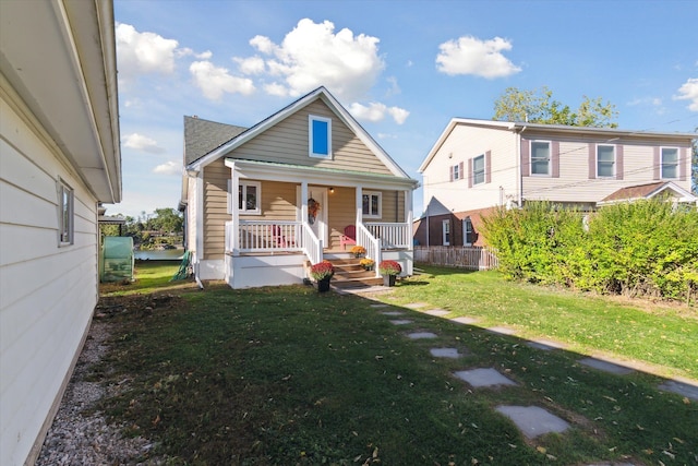 bungalow featuring a porch and a front yard