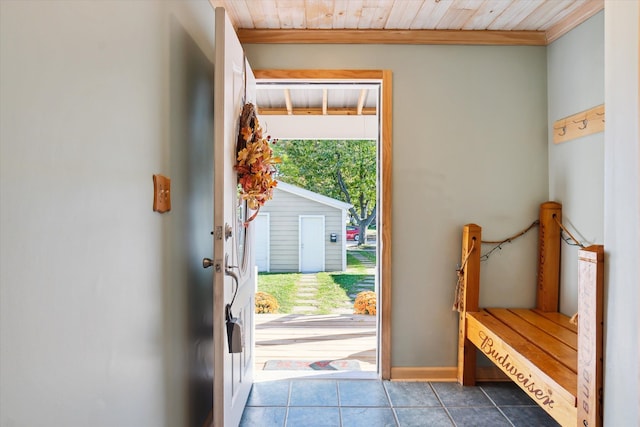 entryway featuring tile patterned flooring, wooden ceiling, and crown molding