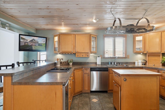 kitchen featuring sink, wooden ceiling, stainless steel appliances, a breakfast bar area, and a kitchen island