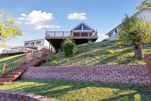 back of house featuring a yard and a deck