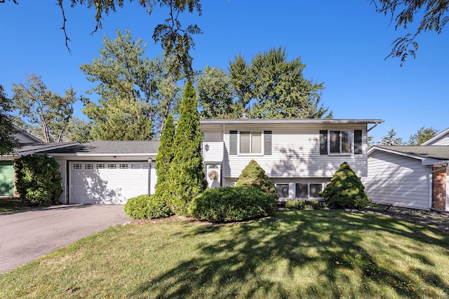 view of front of house featuring a garage and a front lawn