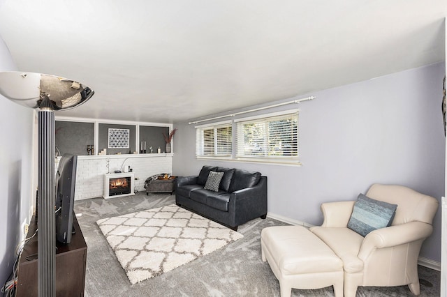 living room with a fireplace and carpet floors