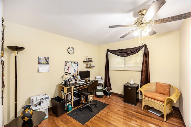 office space with ceiling fan and light hardwood / wood-style floors