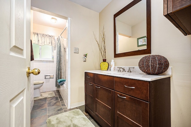 full bathroom with shower / bath combination with curtain, vanity, toilet, and tile walls